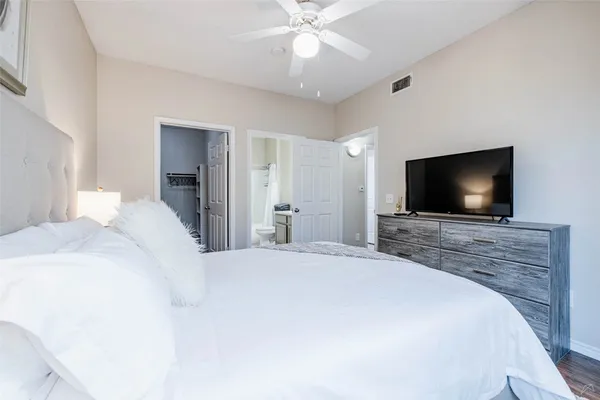 a bedroom with a bed and a flat screen tv