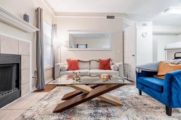 a living room with furniture and a fireplace