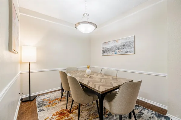 a view of a dining room with furniture and wooden floor