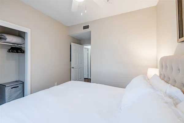 a bedroom with a bed and a mirror