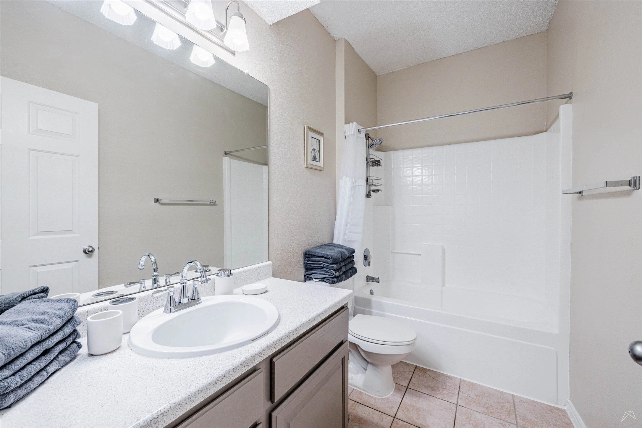 11908 Anderson Mill Road, Unit 312 Cedar Park, TX 78613 - Photo 9 of 25 a bathroom with a granite countertop sink toilet a mirror and shower