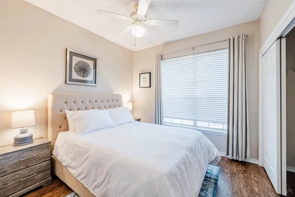 a bedroom with a bed and a window