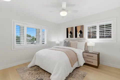 a bedroom with a bed dresser and a window