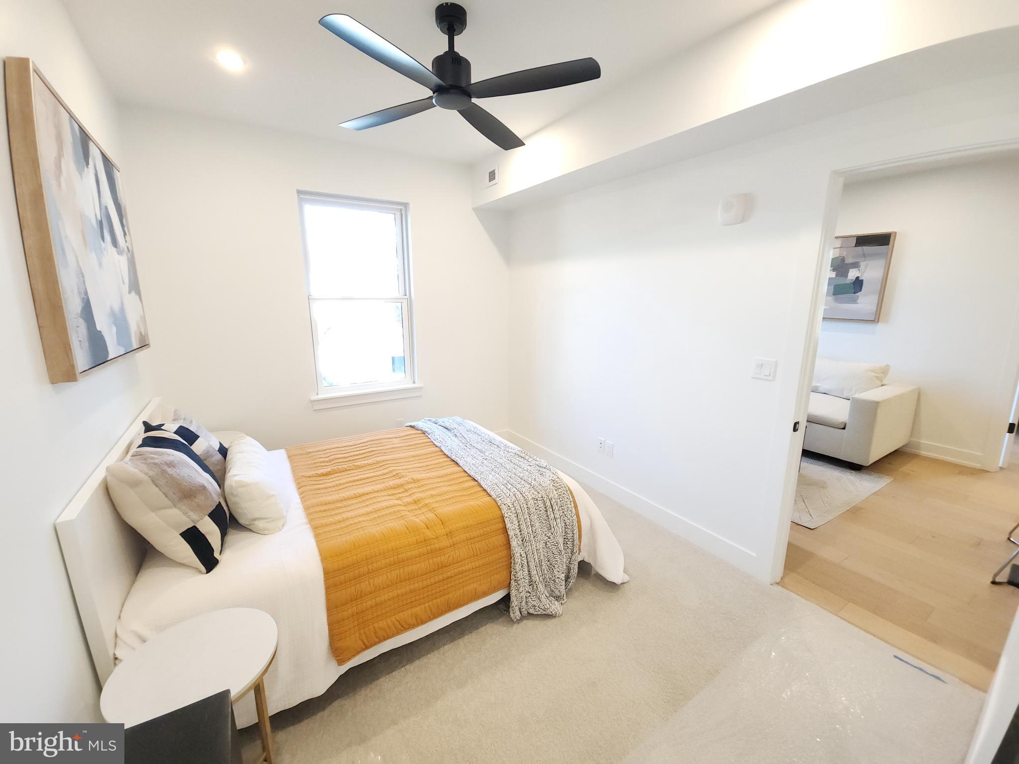 8610 Evergreen Place, Unit 100 Philadelphia, PA 19118 - Photo 12 of 21 a bedroom with a bed and furniture