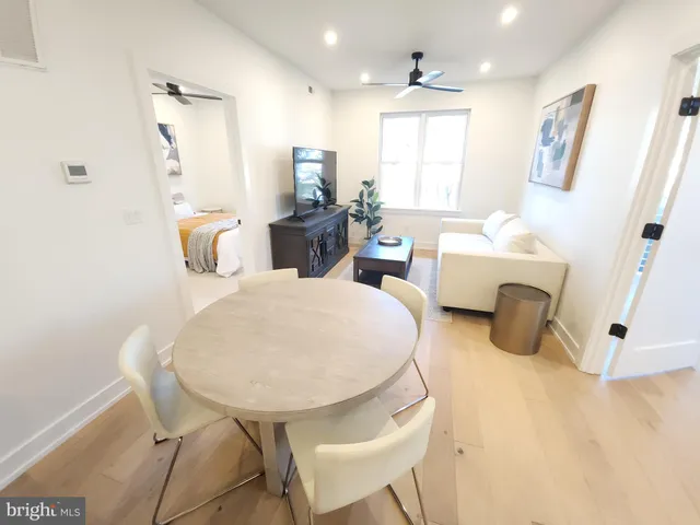 a living room with furniture a table and a chandelier
