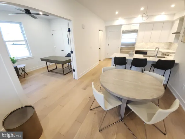 a view of kitchen and dining area with wooden floor