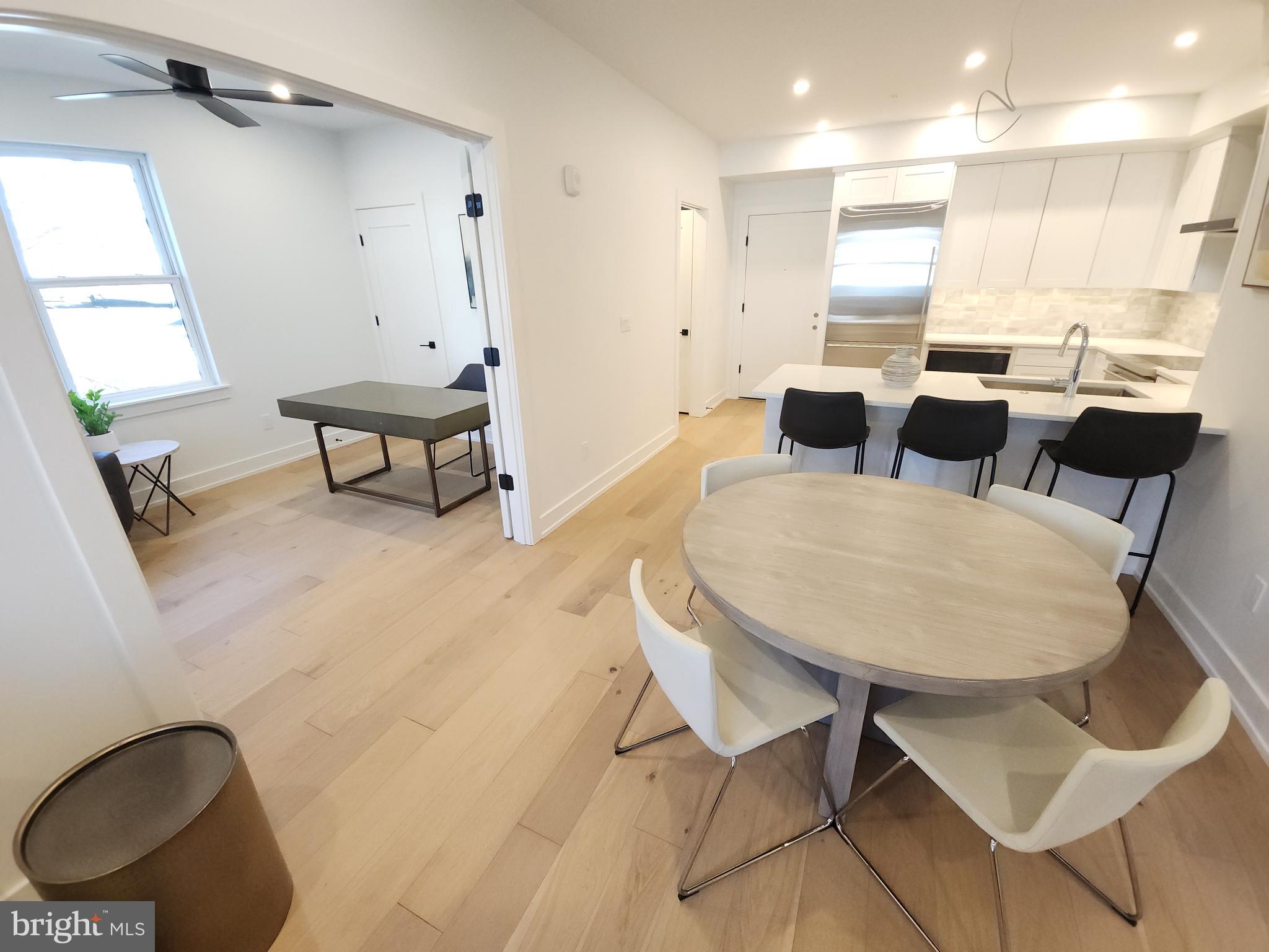 8610 Evergreen Place, Unit 100 Philadelphia, PA 19118 - Photo 7 of 21 a view of kitchen and dining area with wooden floor