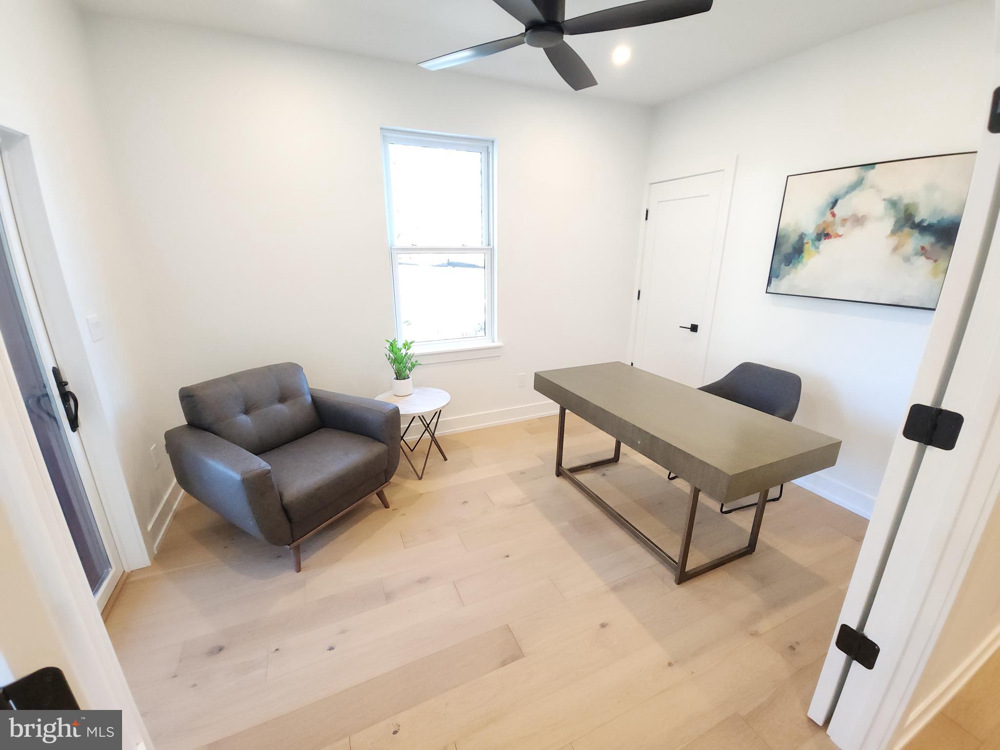 8610 Evergreen Place, Unit 100 Philadelphia, PA 19118 - Photo 8 of 21 a living room with furniture and a window