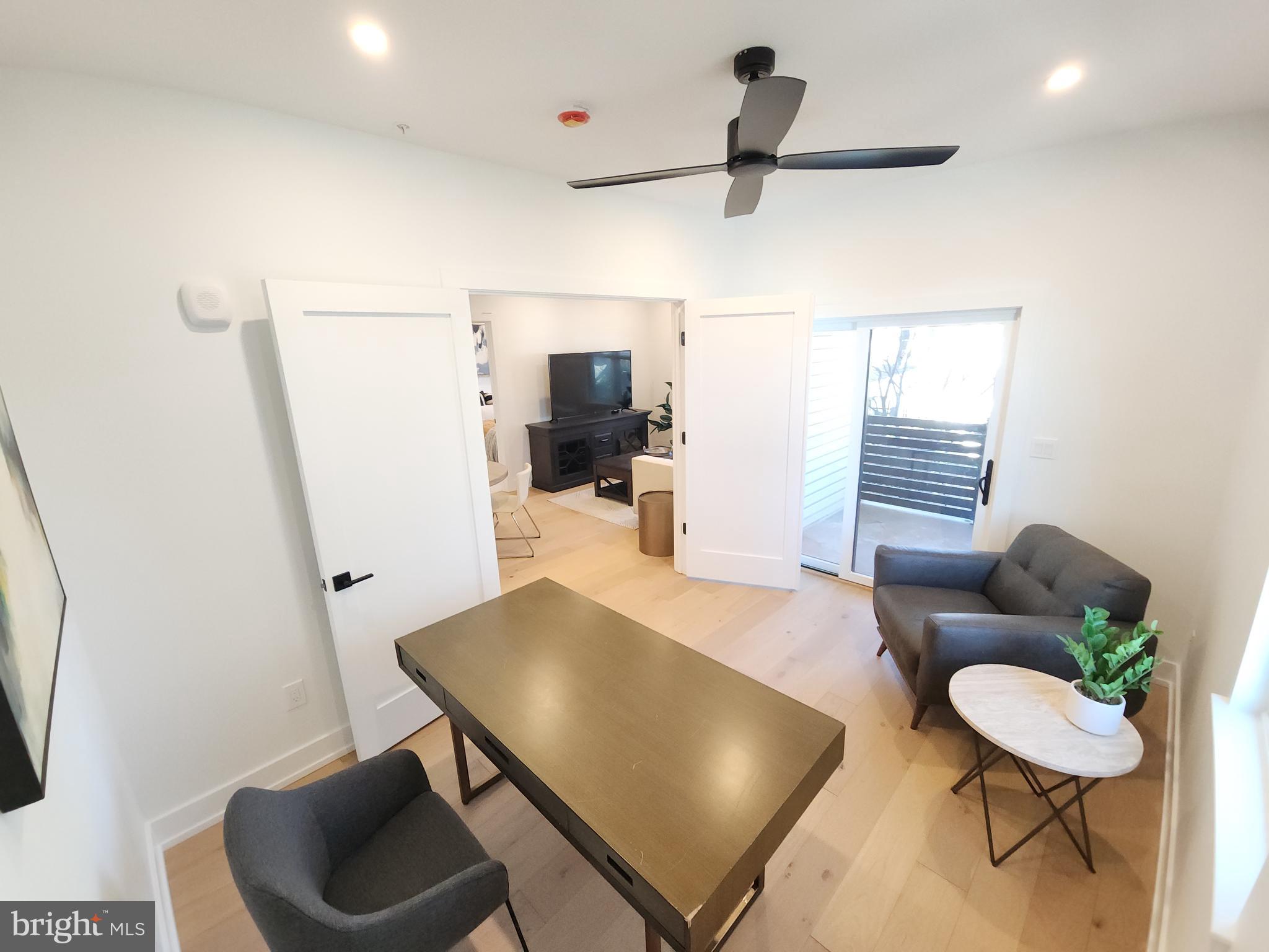 8610 Evergreen Place, Unit 100 Philadelphia, PA 19118 - Photo 9 of 21 a living room with furniture and a wooden floor