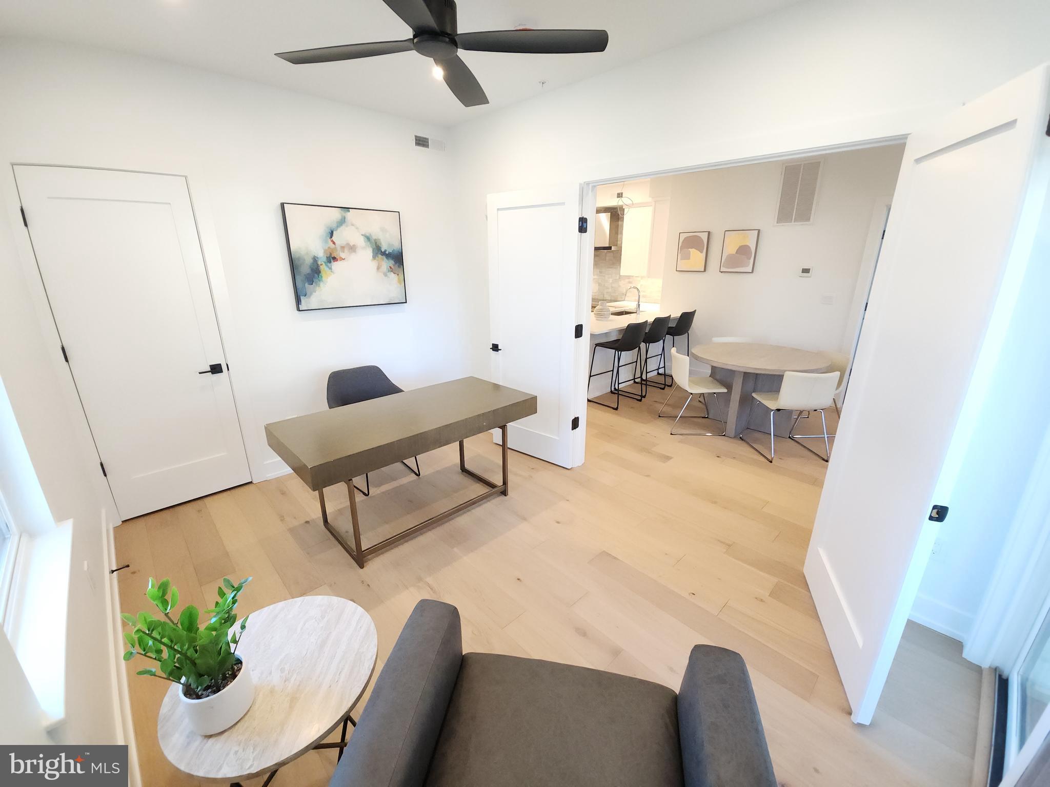8610 Evergreen Place, Unit 100 Philadelphia, PA 19118 - Photo 10 of 21 a living room with furniture and a potted plant