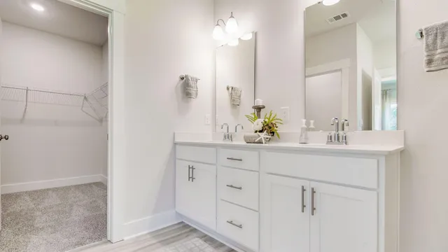 a bathroom with a shower sink and mirror