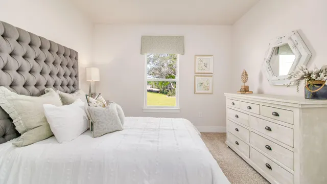 a bedroom with a bed and a night stand