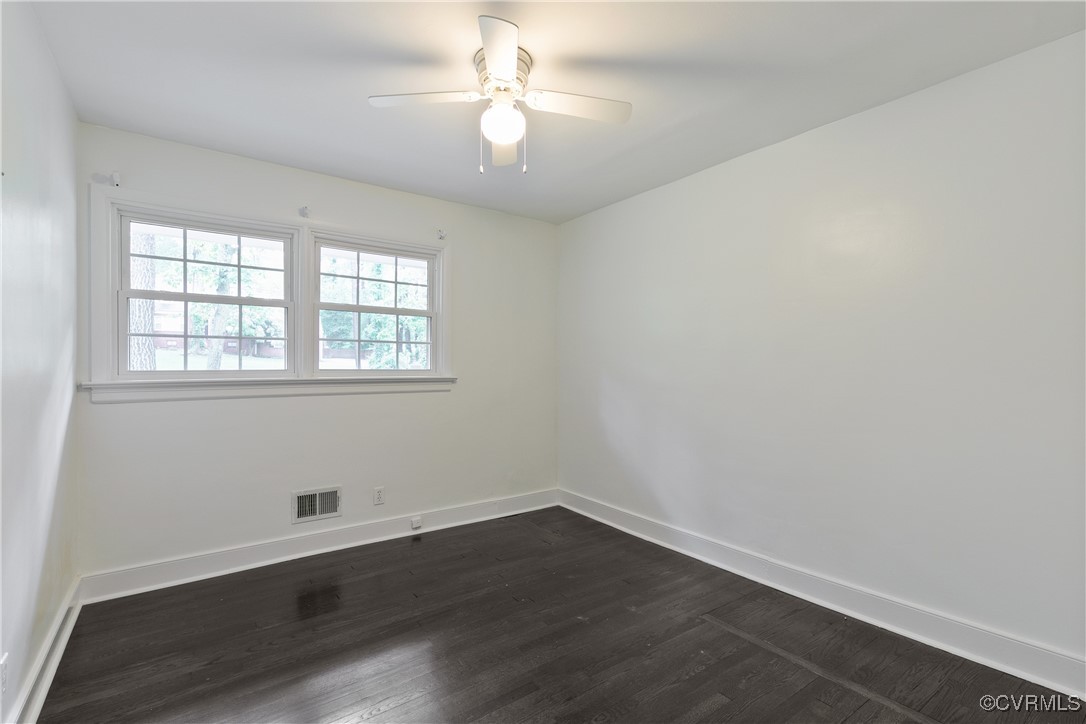 7660 Cherokee Road Richmond, VA 23225 - Photo 29 of 36 an empty room with wooden floor and windows