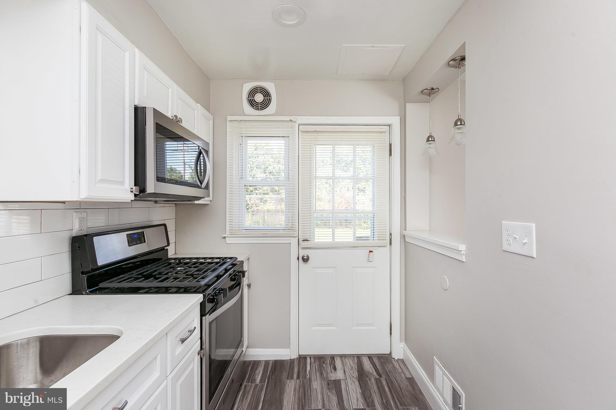 960 Middlesex Road Essex, MD 21221 - Photo 11 of 29 a kitchen with a refrigerator and a sink
