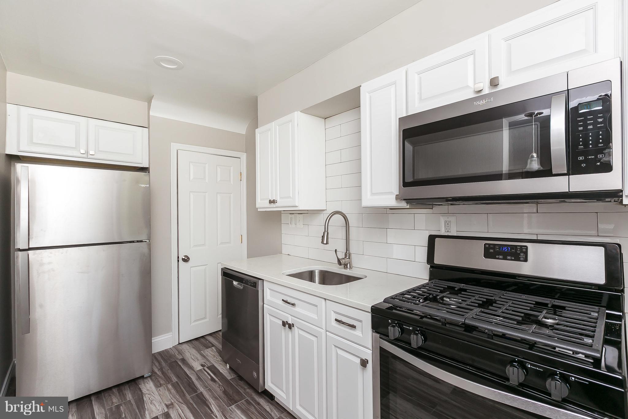 960 Middlesex Road Essex, MD 21221 - Photo 12 of 29 a kitchen with stainless steel appliances a refrigerator stove and microwave