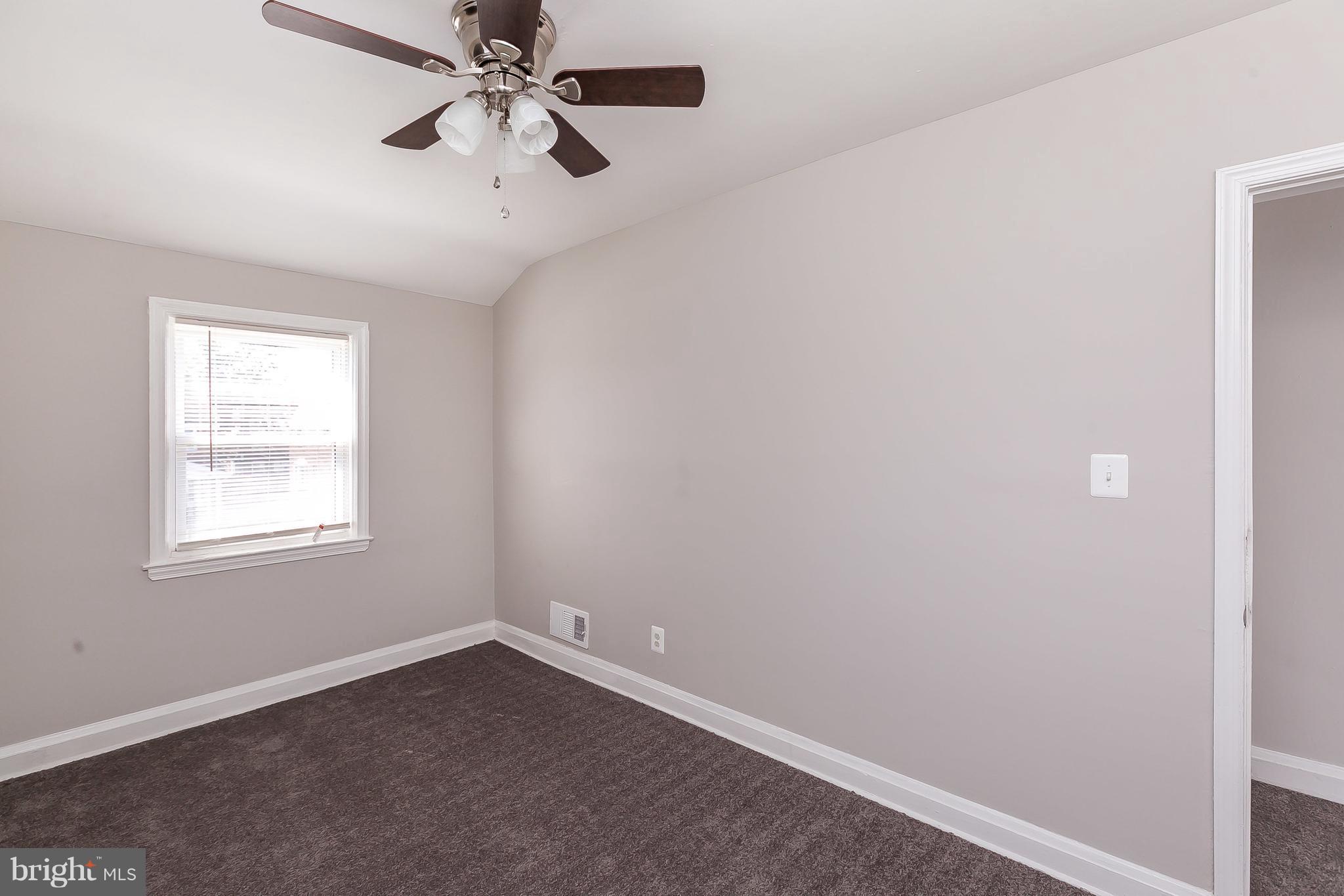 960 Middlesex Road Essex, MD 21221 - Photo 14 of 29 an empty room with windows and fan