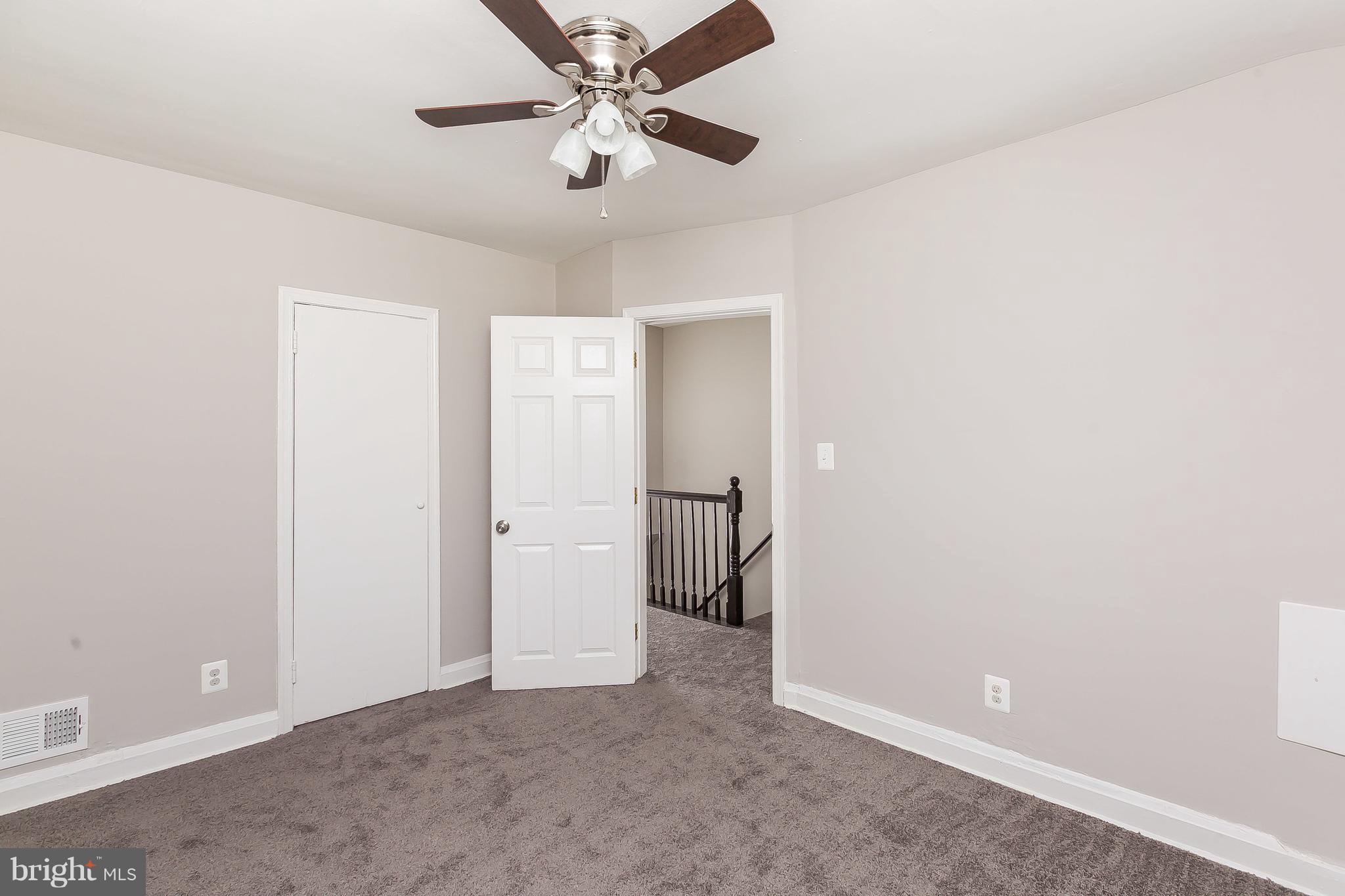 960 Middlesex Road Essex, MD 21221 - Photo 17 of 29 an empty room with chandelier fan and closet