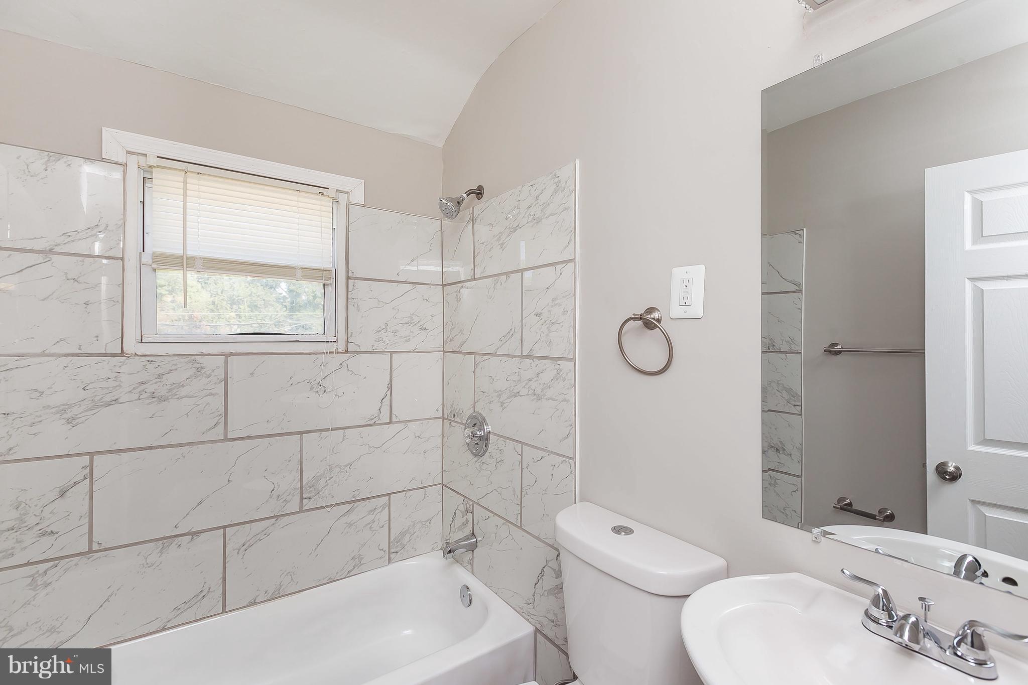 960 Middlesex Road Essex, MD 21221 - Photo 18 of 29 a bathroom with a toilet sink vanity and shower