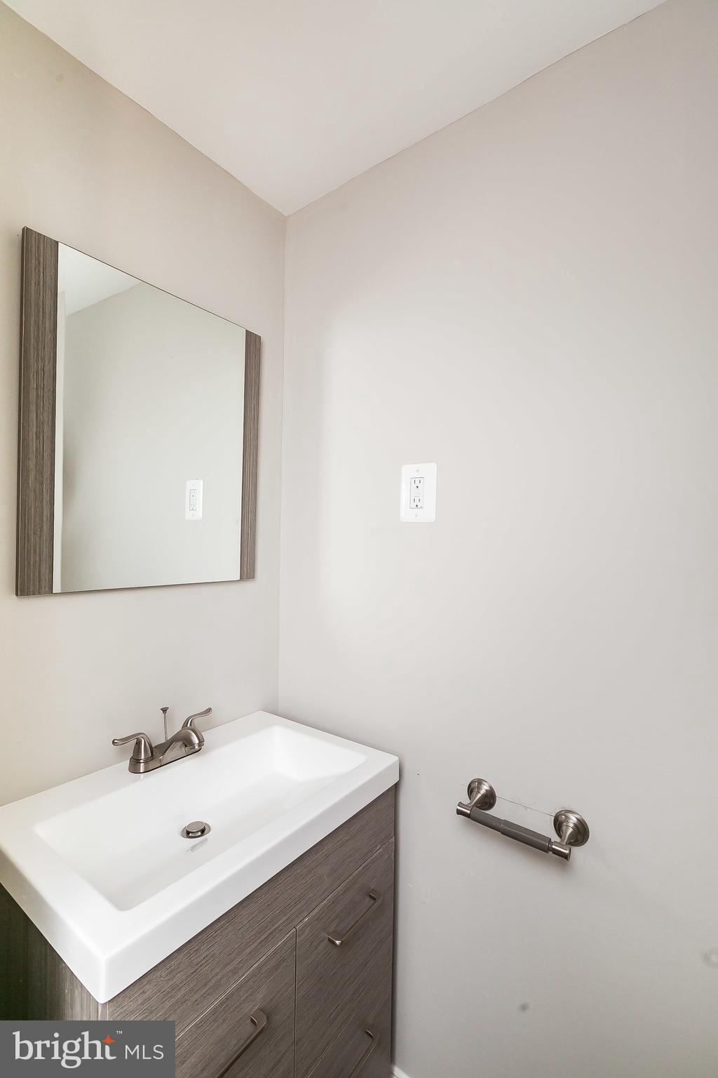 960 Middlesex Road Essex, MD 21221 - Photo 24 of 29 a bathroom with a sink and mirror