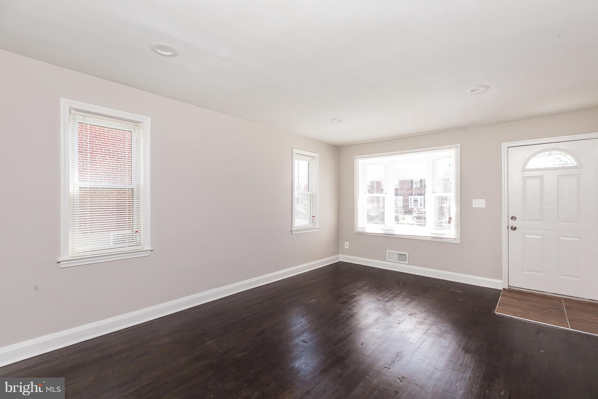 960 Middlesex Road Essex, MD 21221 - Photo 5 of 29 an empty room with wooden floor and windows