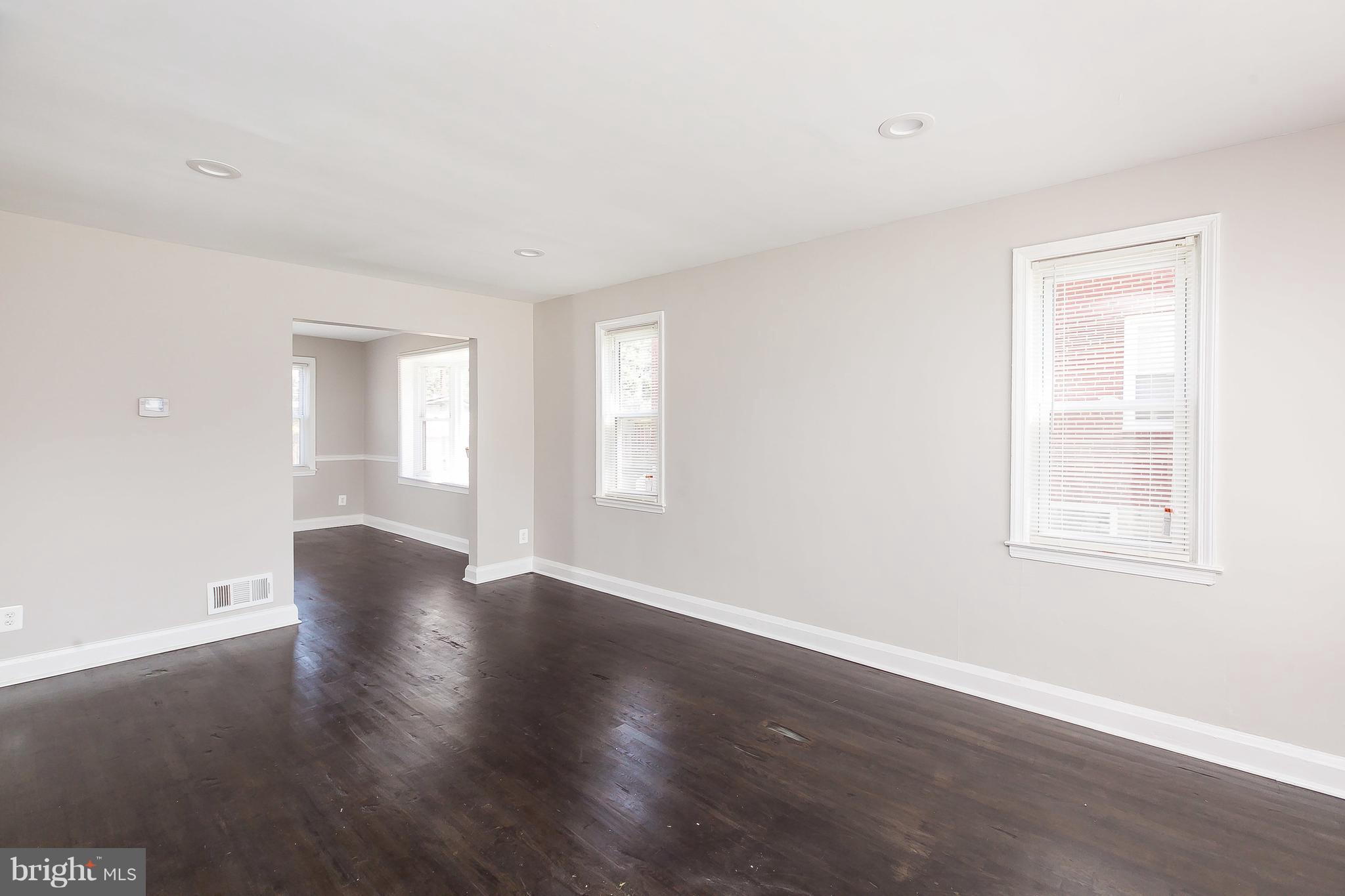 960 Middlesex Road Essex, MD 21221 - Photo 7 of 29 an empty room with wooden floor and windows