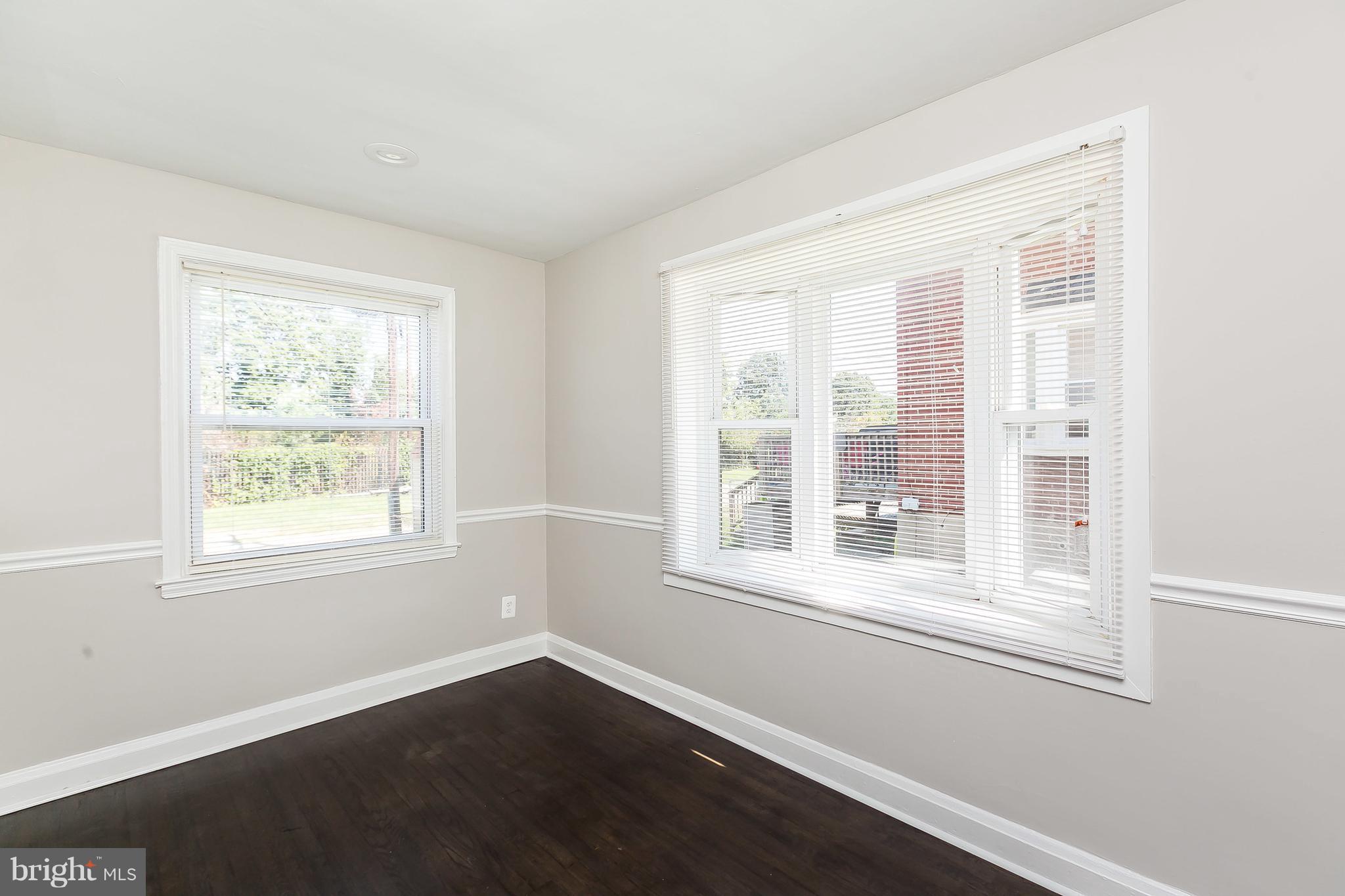960 Middlesex Road Essex, MD 21221 - Photo 8 of 29 a view of an empty room with wooden floor and a window