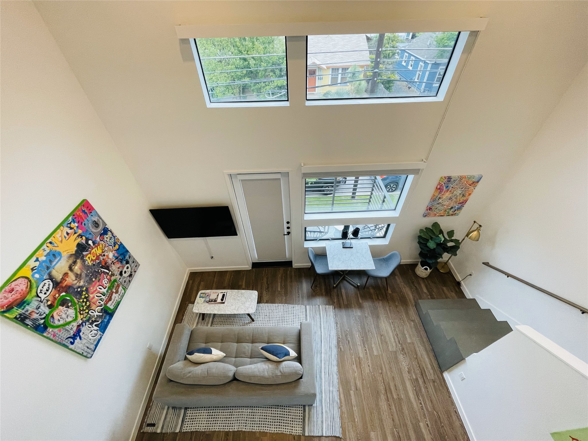 49 Navasota Street, Unit 201 Austin, TX 78702 - Photo 6 of 13 Living room with a high ceiling and wood finished floors
