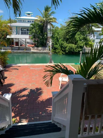 a view of a house with a swimming pool and a yard