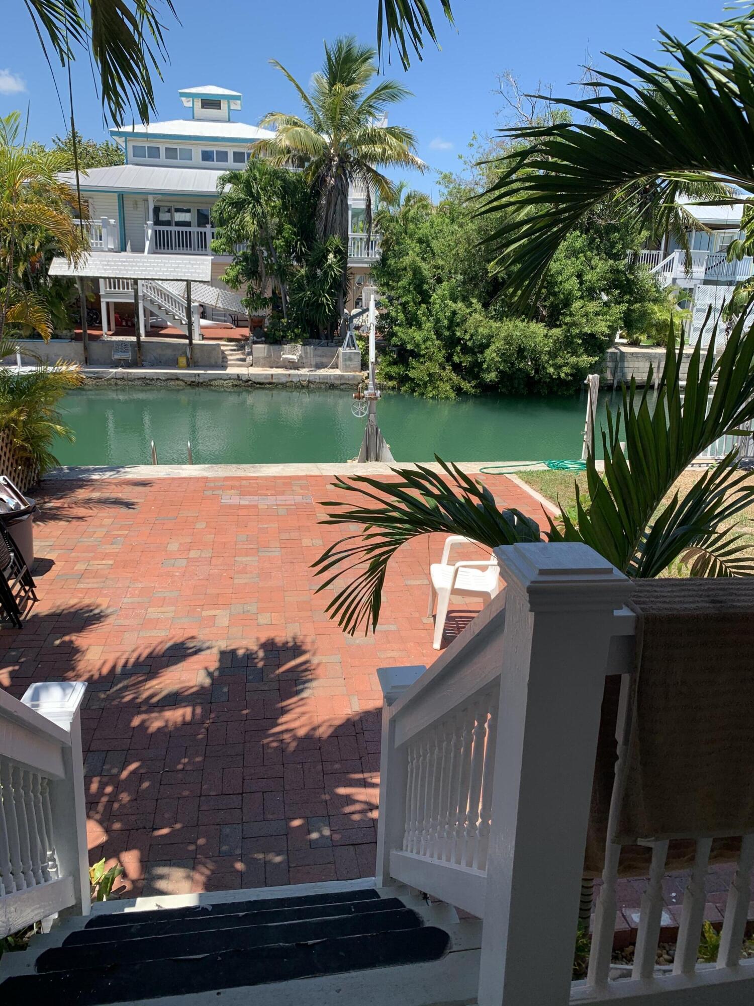 a view of a house with a swimming pool and a yard