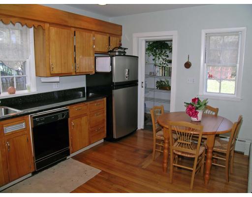 33 Gale Road Belmont, MA 02478 - Photo 5 of 13 a kitchen with a wooden table and chairs