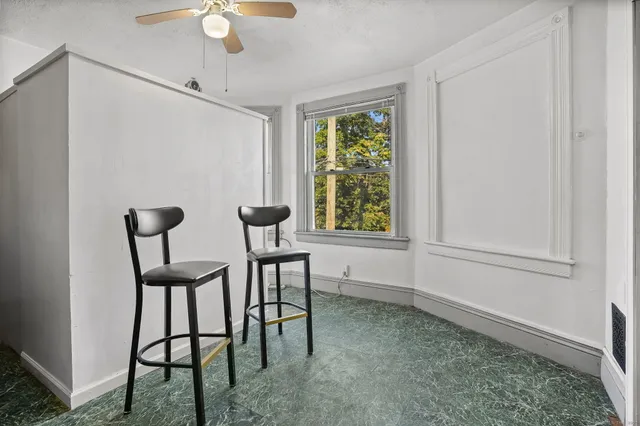 a view of a livingroom with furniture and a window