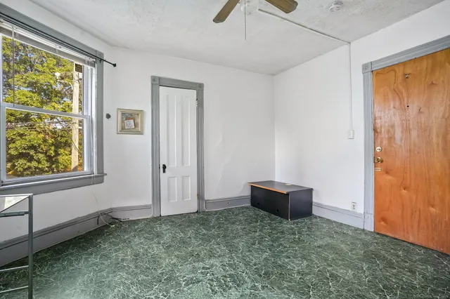 a kitchen with a refrigerator and window