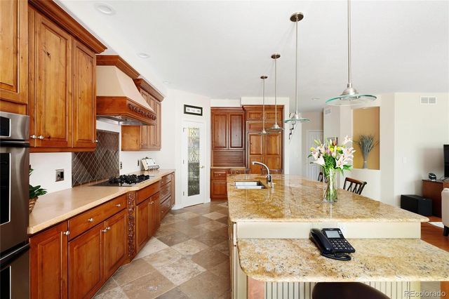 a large kitchen with kitchen island granite countertop a large counter top appliances and cabinets