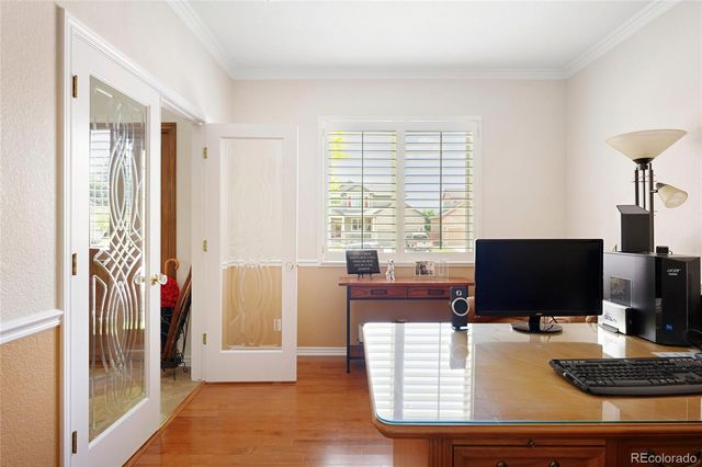 a view of a workspace with furniture and a window