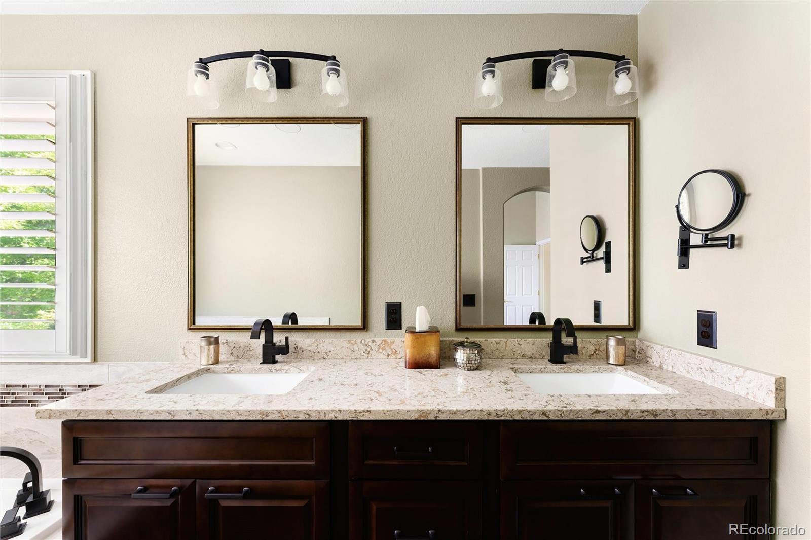 10523 West Peakview Place Littleton, CO 80127 - Photo 25 of 40 a bathroom with a granite countertop sink and a mirror