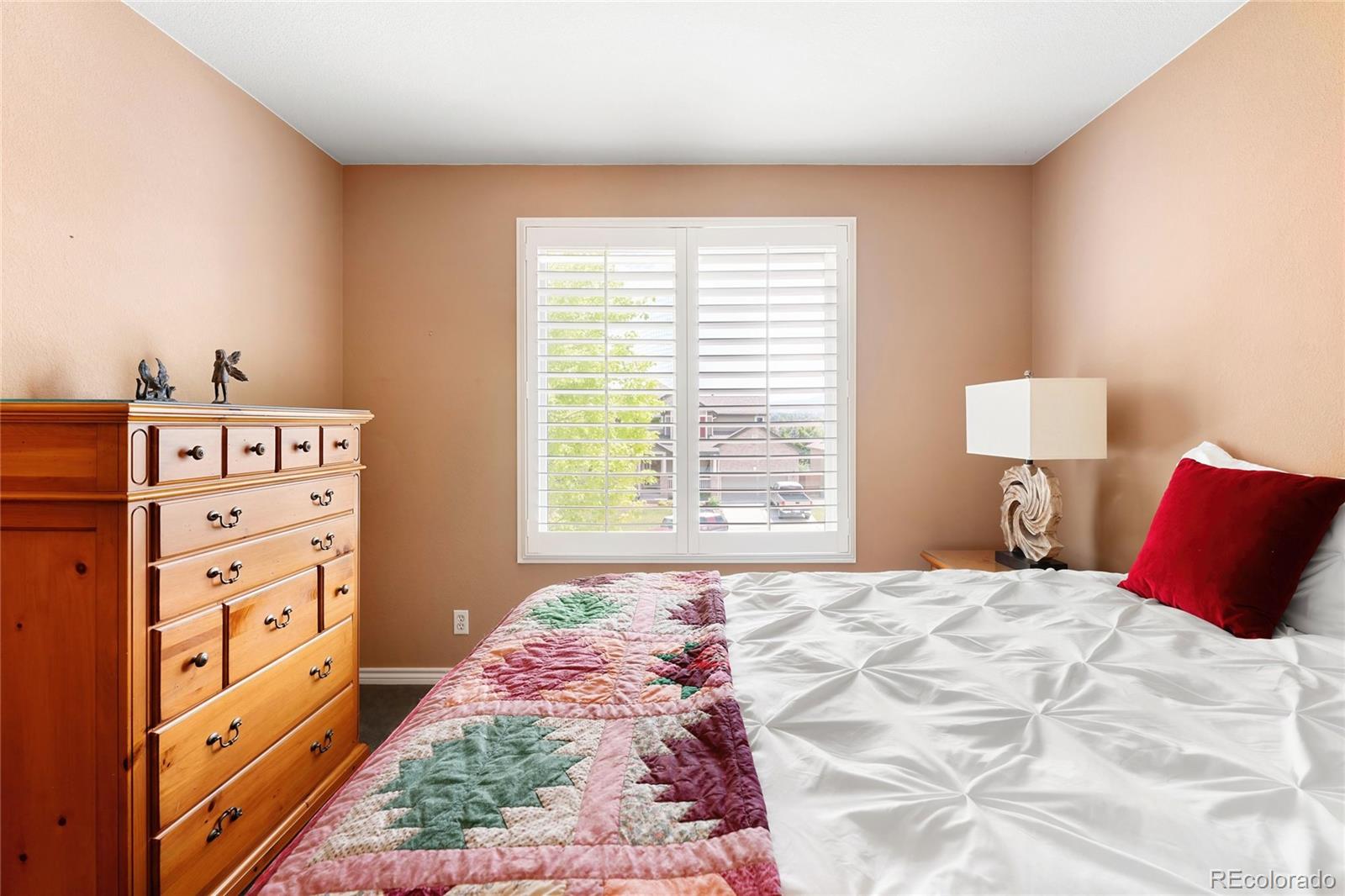 10523 West Peakview Place Littleton, CO 80127 - Photo 27 of 40 a bedroom with a bed and a window