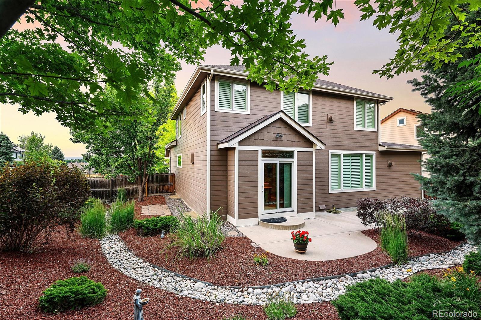 10523 West Peakview Place Littleton, CO 80127 - Photo 35 of 40 a front view of a house with garden