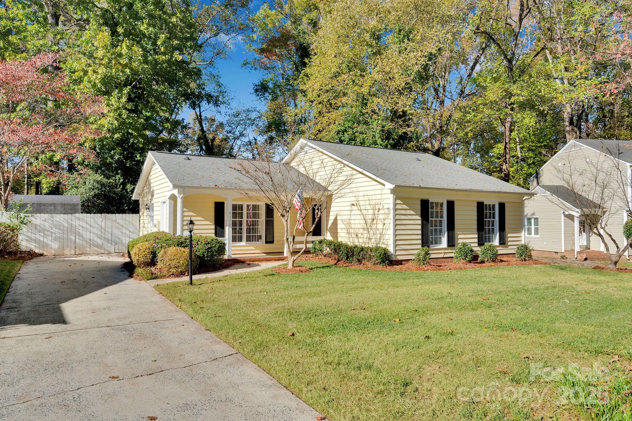 a front view of a house with a yard and trees