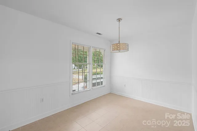 a view of an empty room with windows