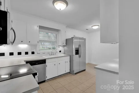 a kitchen with stainless steel appliances a refrigerator sink and cabinets