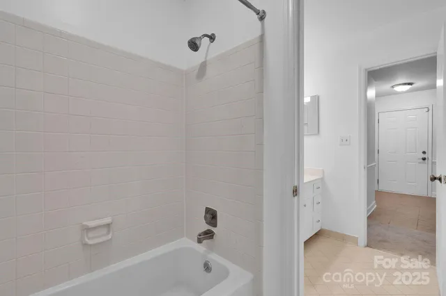 a bathroom with a bathtub and shower