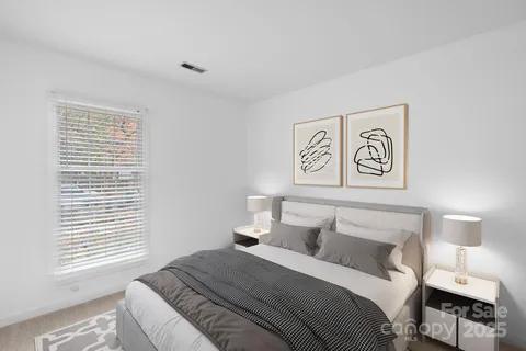 a bedroom with a bed and a night stand