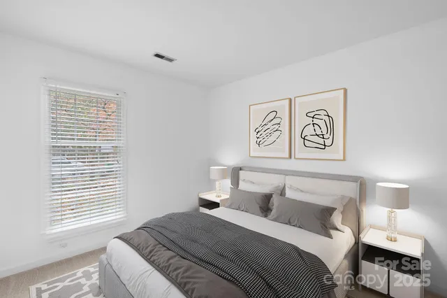 a bedroom with a bed and a night stand