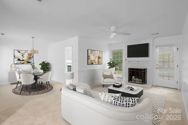 a living room with furniture a fireplace and a flat screen tv