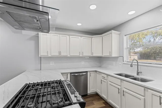 a kitchen with a sink and cabinets
