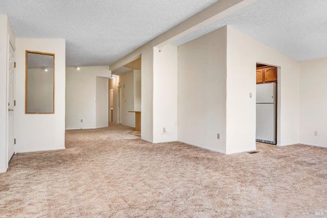 a kitchen with stainless steel appliances granite countertop a refrigerator and a stove