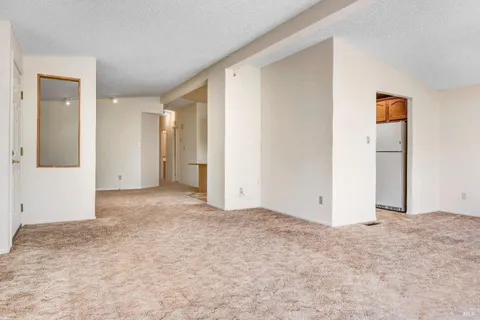 a kitchen with stainless steel appliances granite countertop a refrigerator and a stove
