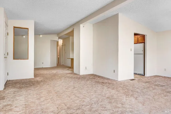 a kitchen with stainless steel appliances granite countertop a refrigerator and a stove