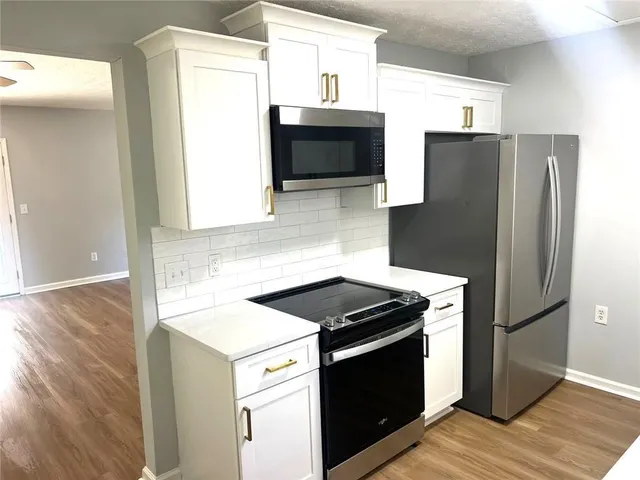 a kitchen with stainless steel appliances kitchen island a sink stove and refrigerator
