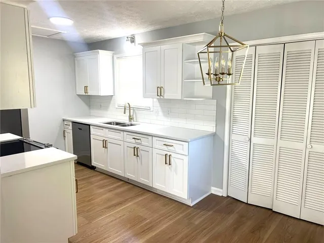 a kitchen that has a lot of cabinets in it